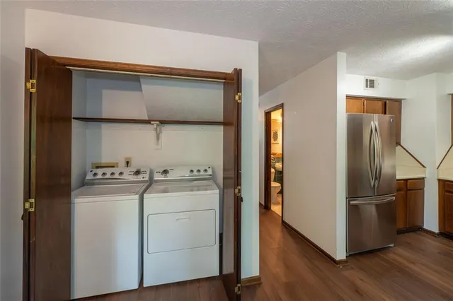 a kitchen with a refrigerator and a stove