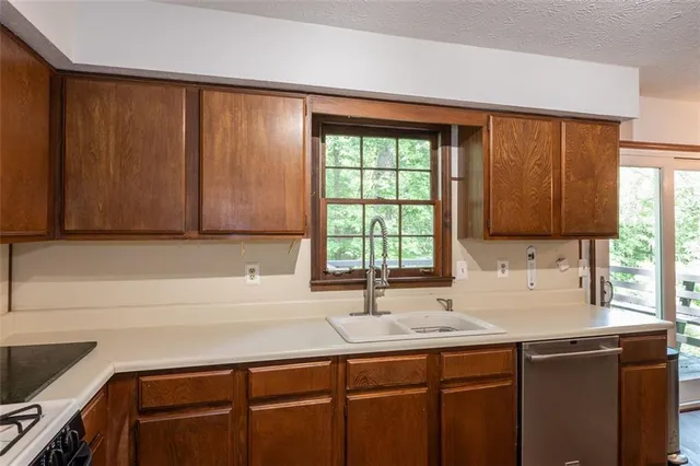 a kitchen with a sink cabinets and window