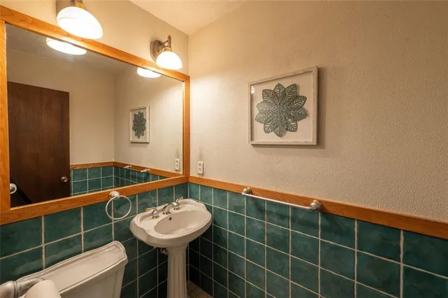 a bathroom with a sink a mirror and a shower