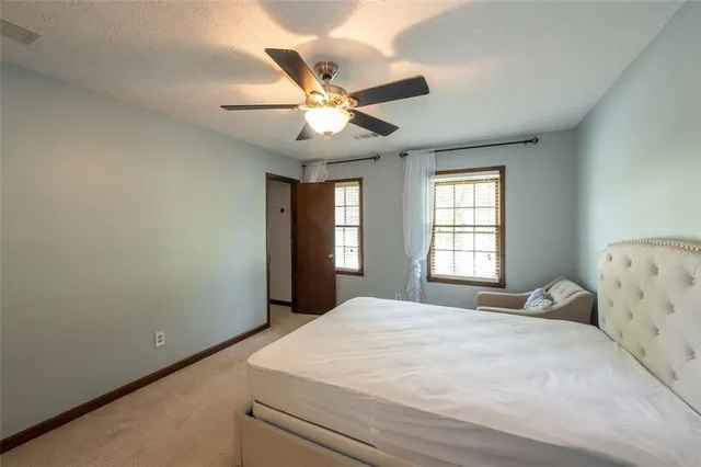 a bedroom with a large bed and a window