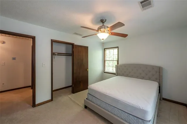 a bedroom with a large bed and a chandelier