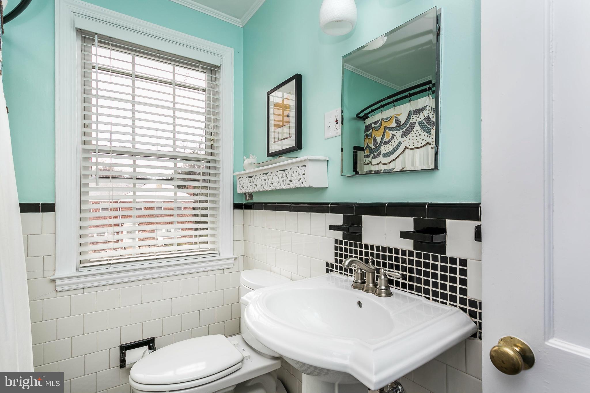 1823 Glen Ridge Road Baltimore, MD 21286 - Photo 22 of 28 a bathroom with a sink a toilet and a window