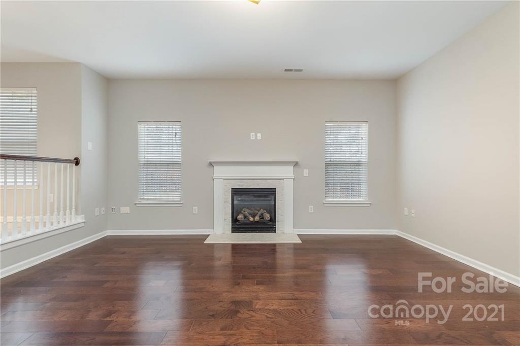 7837 East Berkeley Road Denver, NC 28037 - Photo 3 of 20 an empty room with windows and fireplace