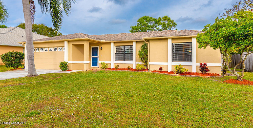731 Raleigh Road Southeast Palm Bay, FL 32909 - Photo 1 of 36 a front view of a house with a yard