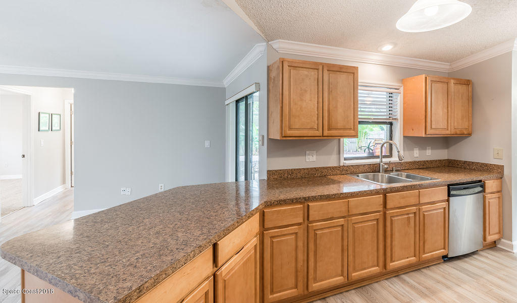 731 Raleigh Road Southeast Palm Bay, FL 32909 - Photo 15 of 36 a kitchen with wooden cabinets