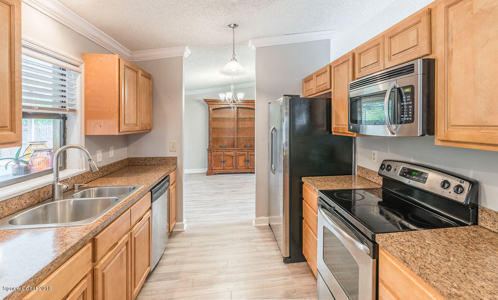 731 Raleigh Road Southeast Palm Bay, FL 32909 - Photo 16 of 36 a kitchen that has a sink and a stove