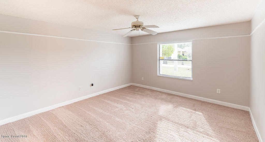 731 Raleigh Road Southeast Palm Bay, FL 32909 - Photo 21 of 36 an empty room with a window