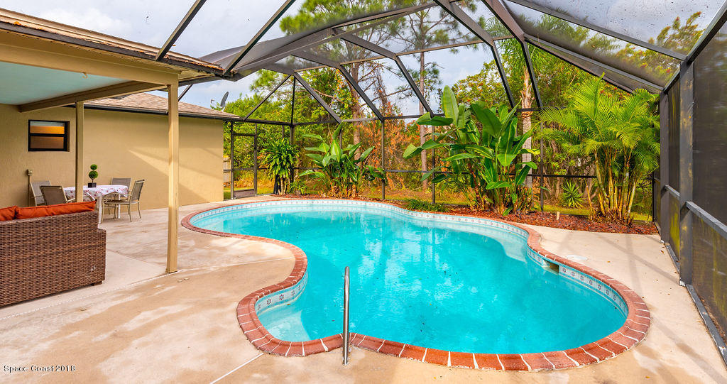 731 Raleigh Road Southeast Palm Bay, FL 32909 - Photo 29 of 36 a view of a swimming pool with a patio