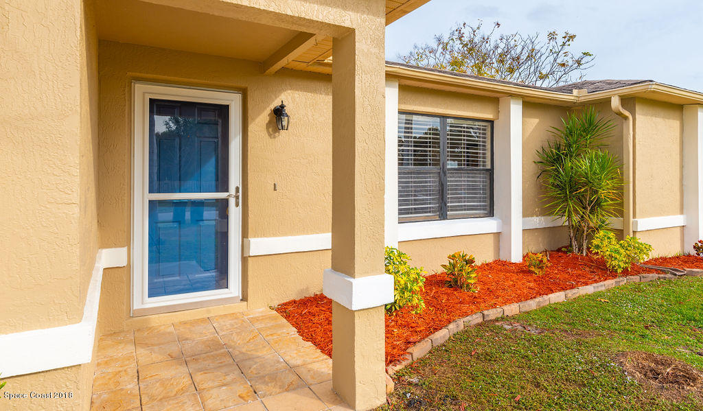 731 Raleigh Road Southeast Palm Bay, FL 32909 - Photo 4 of 36 a front view of a house with a yard