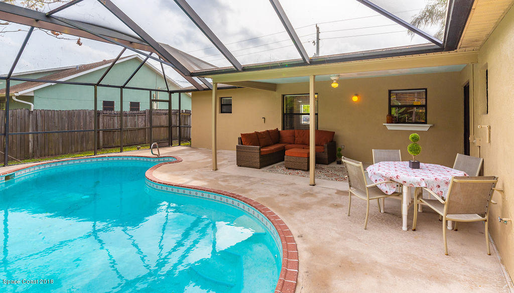731 Raleigh Road Southeast Palm Bay, FL 32909 - Photo 31 of 36 a backyard of a house with table and chairs