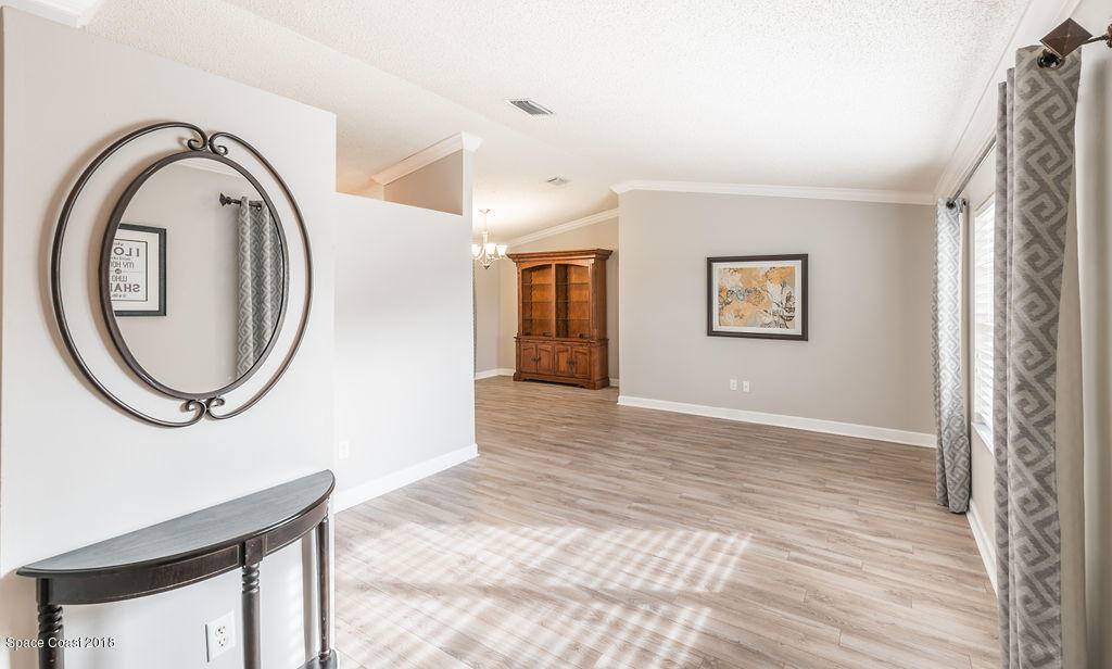 731 Raleigh Road Southeast Palm Bay, FL 32909 - Photo 6 of 36 a view of a room with wooden floor and a window
