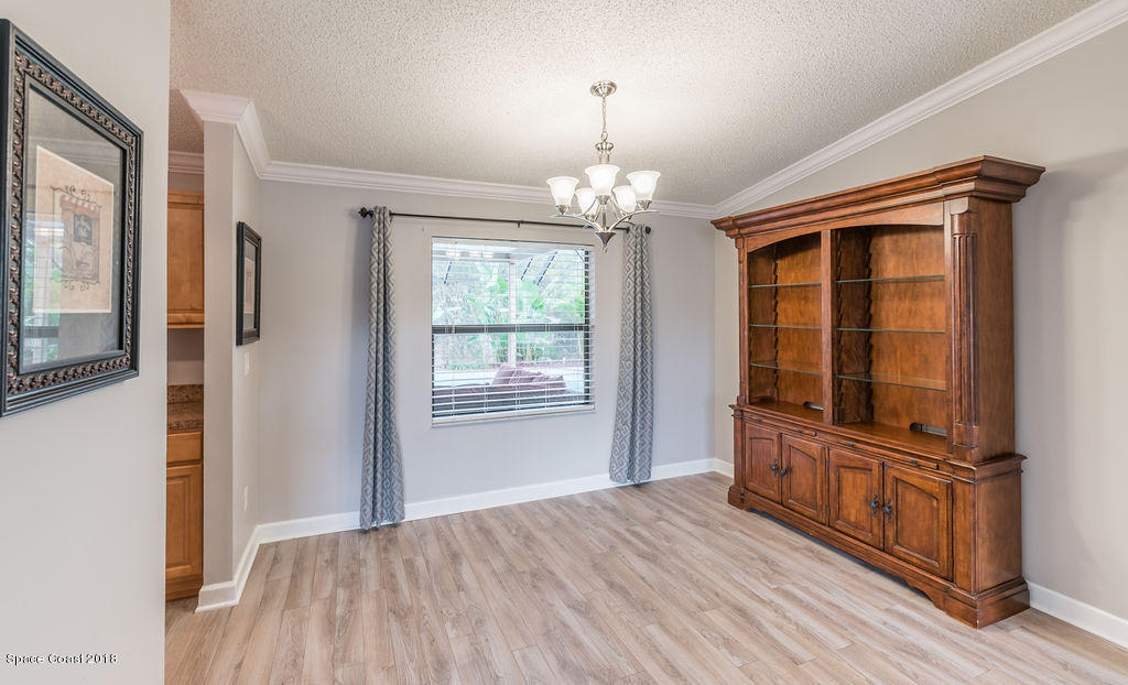 731 Raleigh Road Southeast Palm Bay, FL 32909 - Photo 9 of 36 wooden floor chandelier and windows in a room