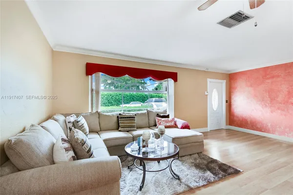 a living room with furniture and a large window