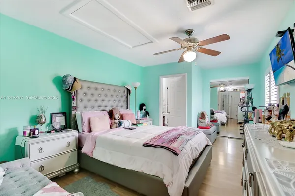 a bedroom with a bed and ceiling fan