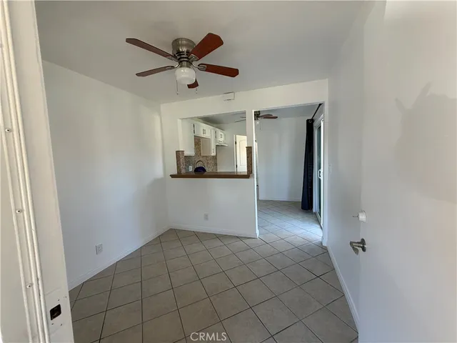 a view of a livingroom with a ceiling fan and wooden floor