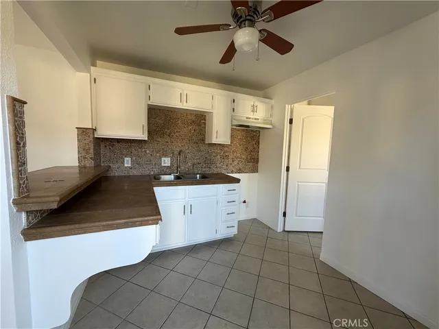 a kitchen with a sink cabinets and appliances
