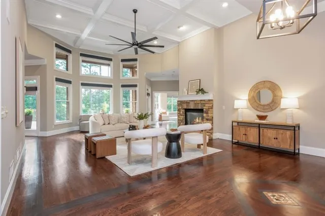 a living room with furniture a fireplace and a potted plant