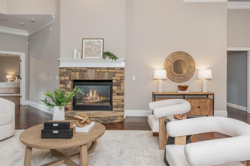 3505 Watson Road Cumming, GA 30028 - Photo 18 of 87 a living room with furniture a fireplace and a potted plant