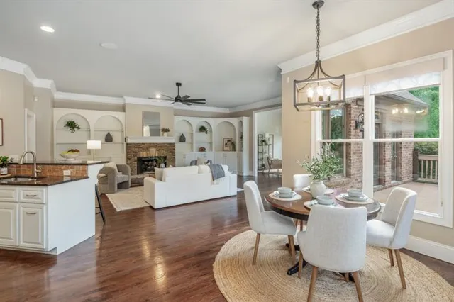 a living room with fireplace furniture and a large window