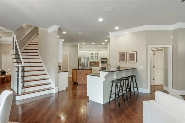 a living room with furniture a fireplace and a large window
