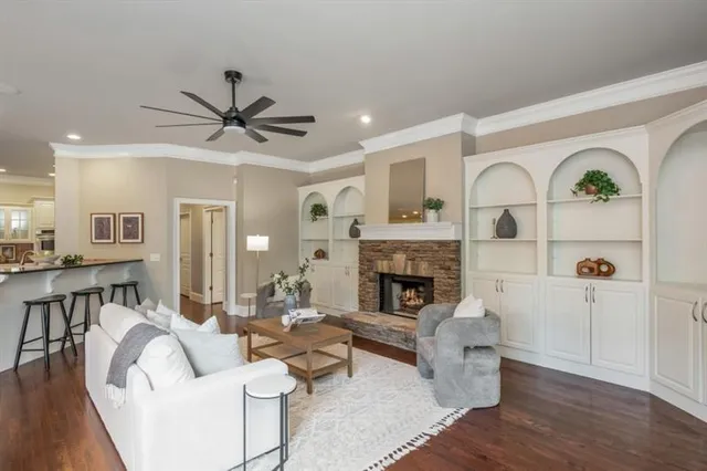 a living room with furniture and large windows