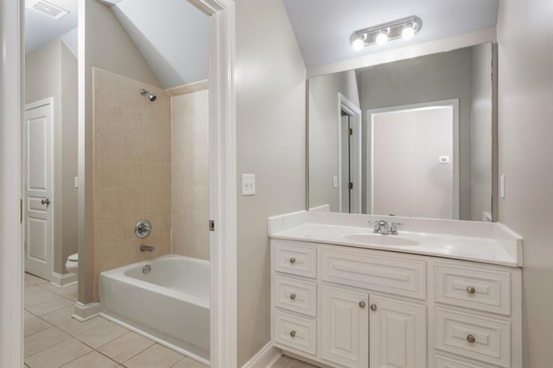 3505 Watson Road Cumming, GA 30028 - Photo 62 of 87 a bathroom with a tub a sink double vanity and a mirror