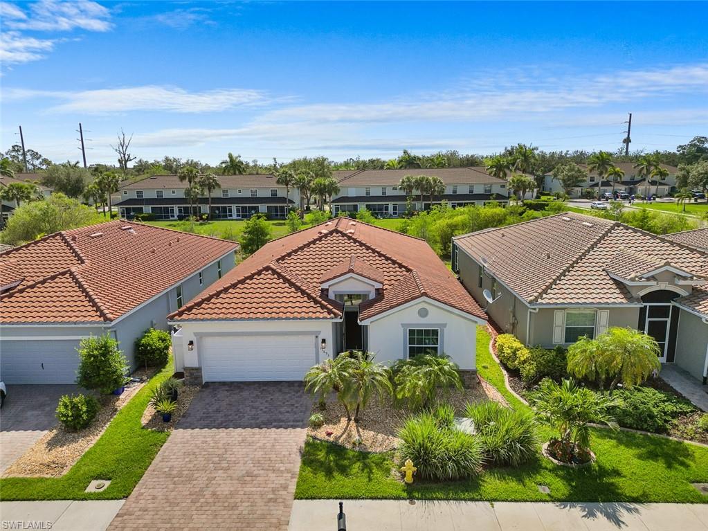 11693 Eros Road Lehigh Acres, FL 33971 - Photo 17 of 21 a aerial view of a house with a big yard plants and large trees