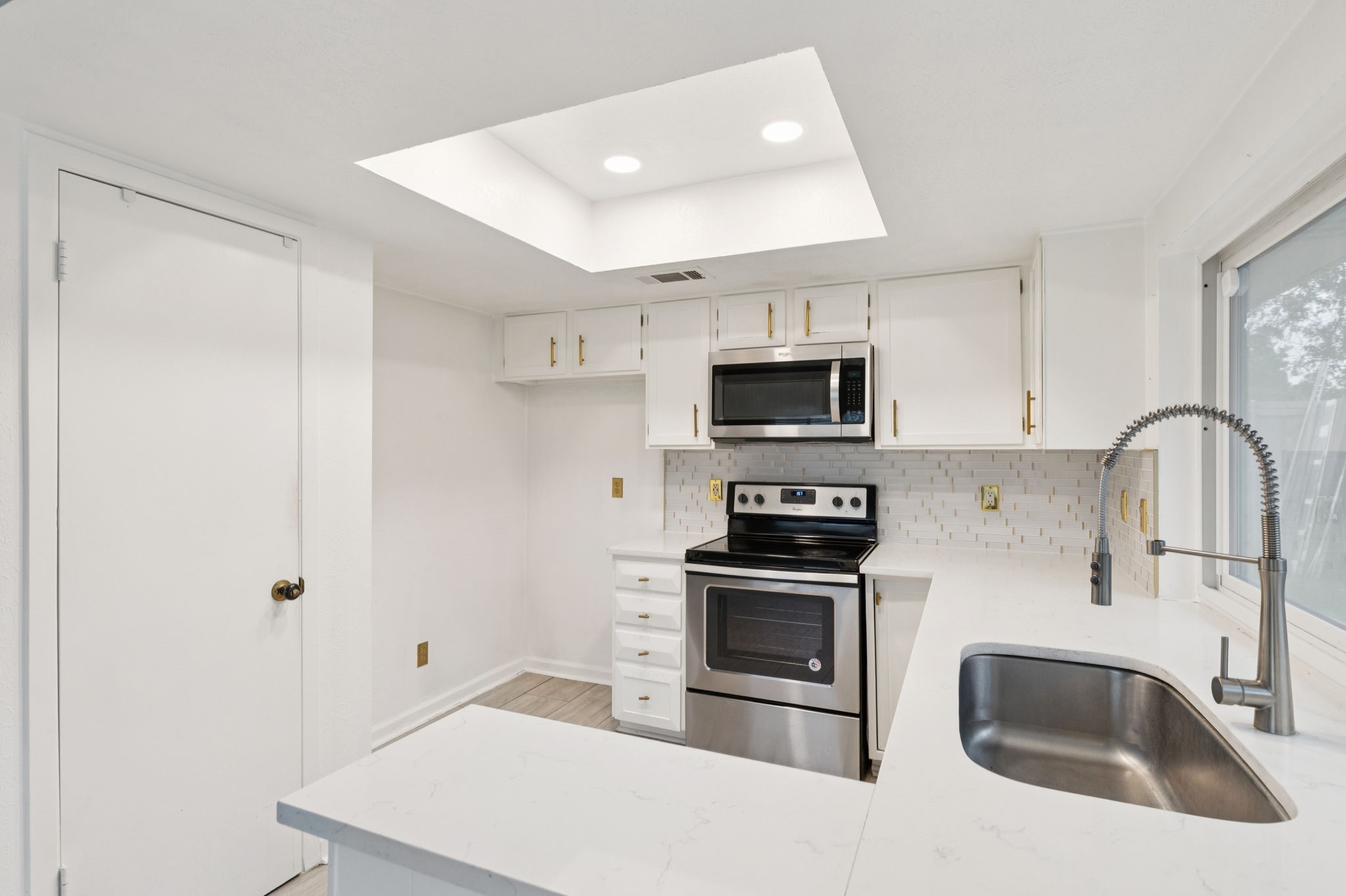 910 Via Valencia Mesquite, TX 75150 - Photo 12 of 23 a kitchen with stainless steel appliances granite countertop a sink and a stove top oven with wooden floor