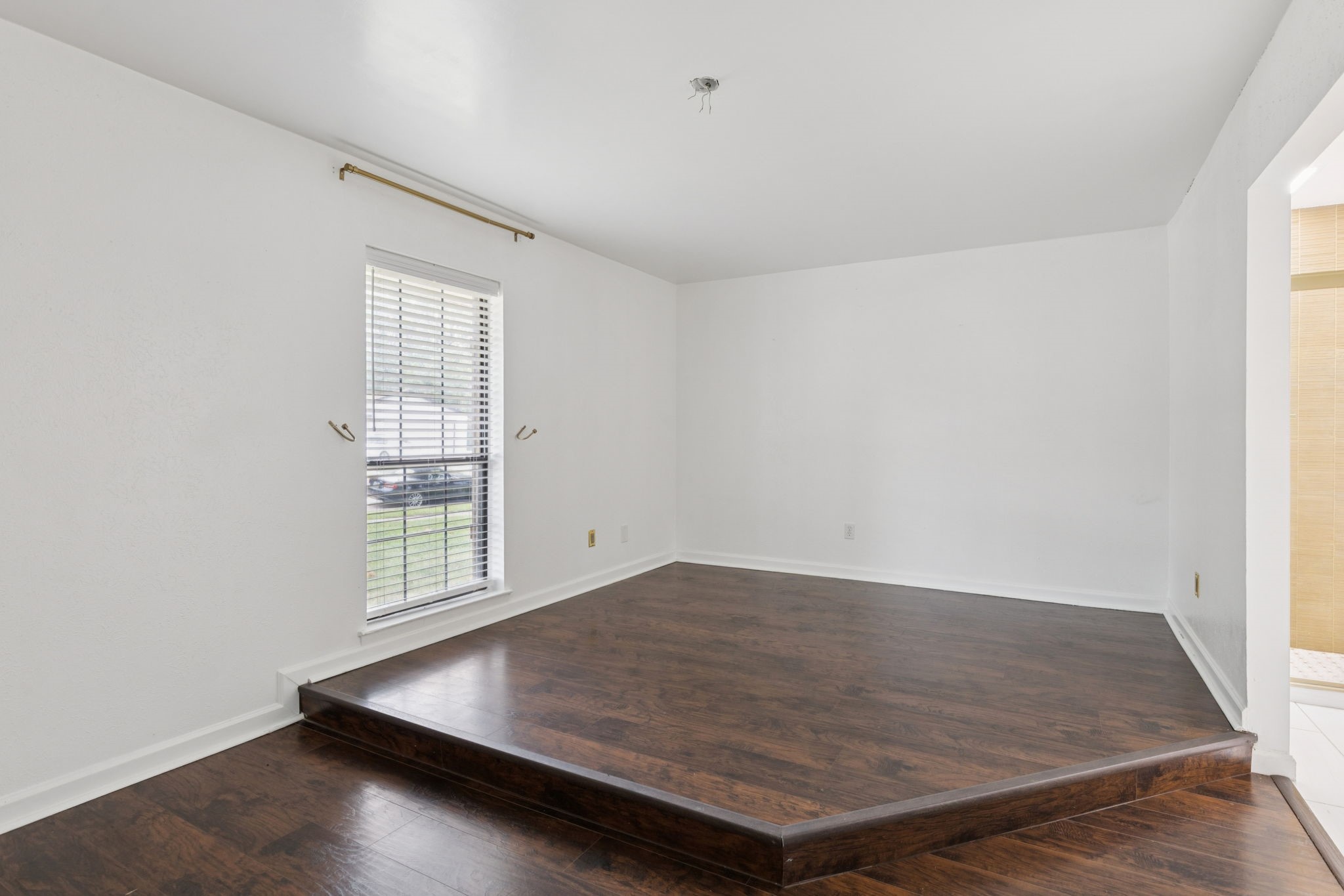 910 Via Valencia Mesquite, TX 75150 - Photo 13 of 23 an empty room with wooden floor and windows
