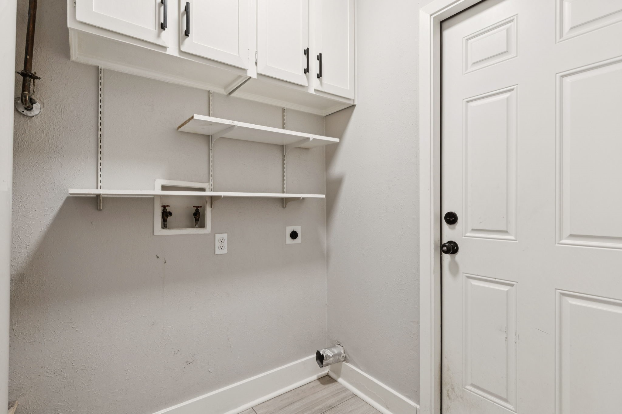 910 Via Valencia Mesquite, TX 75150 - Photo 18 of 23 a view of a small space with racks on the wall