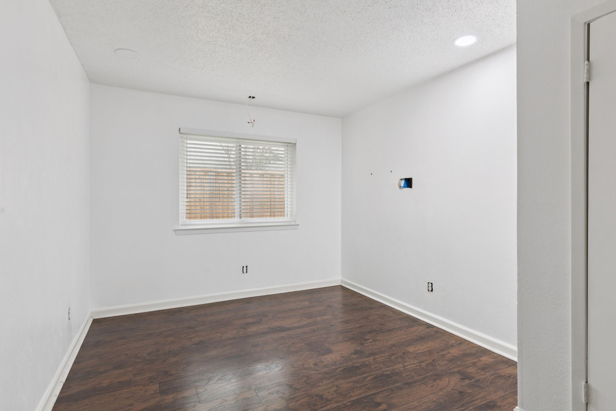910 Via Valencia Mesquite, TX 75150 - Photo 19 of 23 an empty room with wooden floor and windows