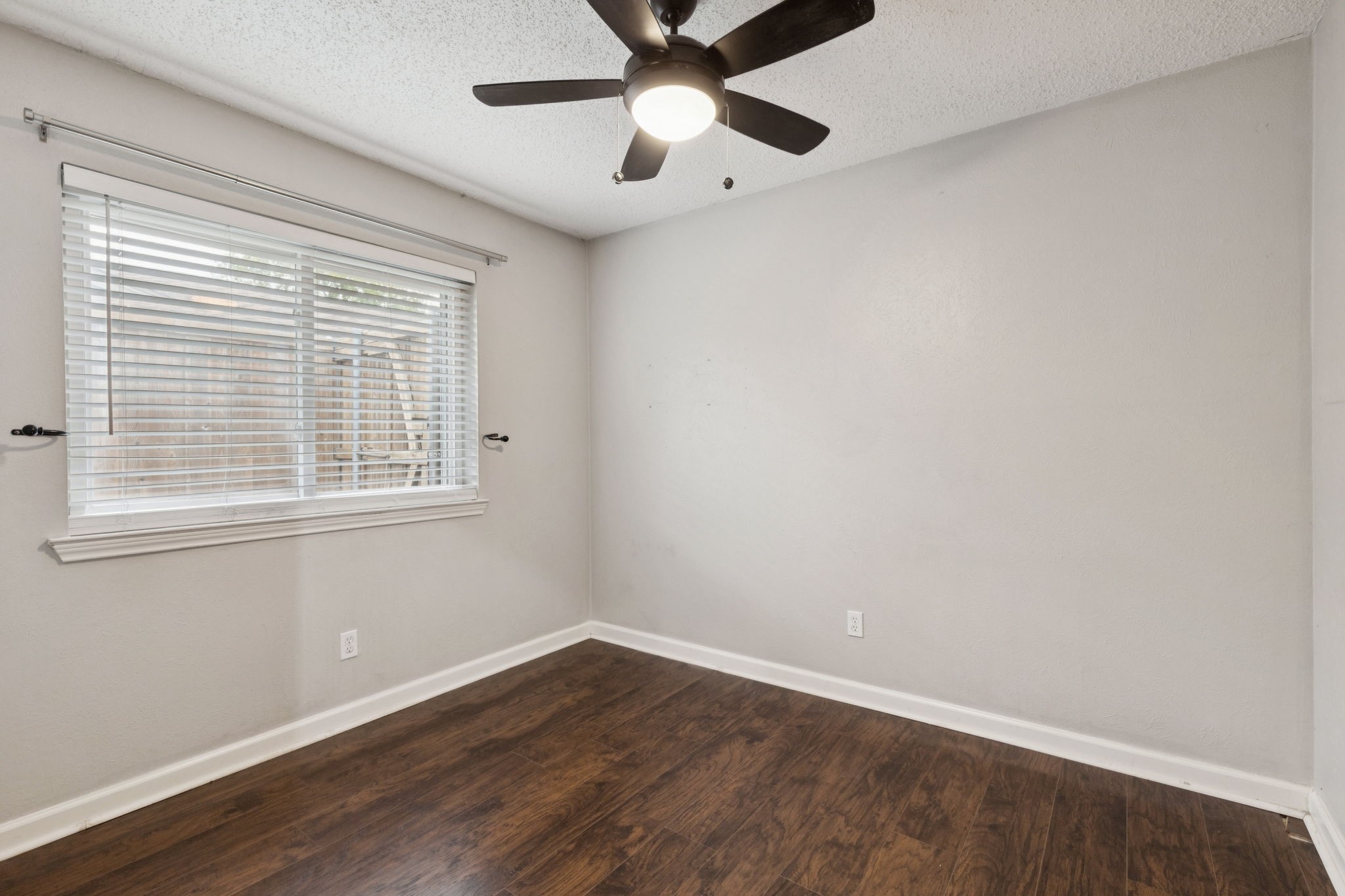910 Via Valencia Mesquite, TX 75150 - Photo 20 of 23 a view of an empty room with window and wooden floor