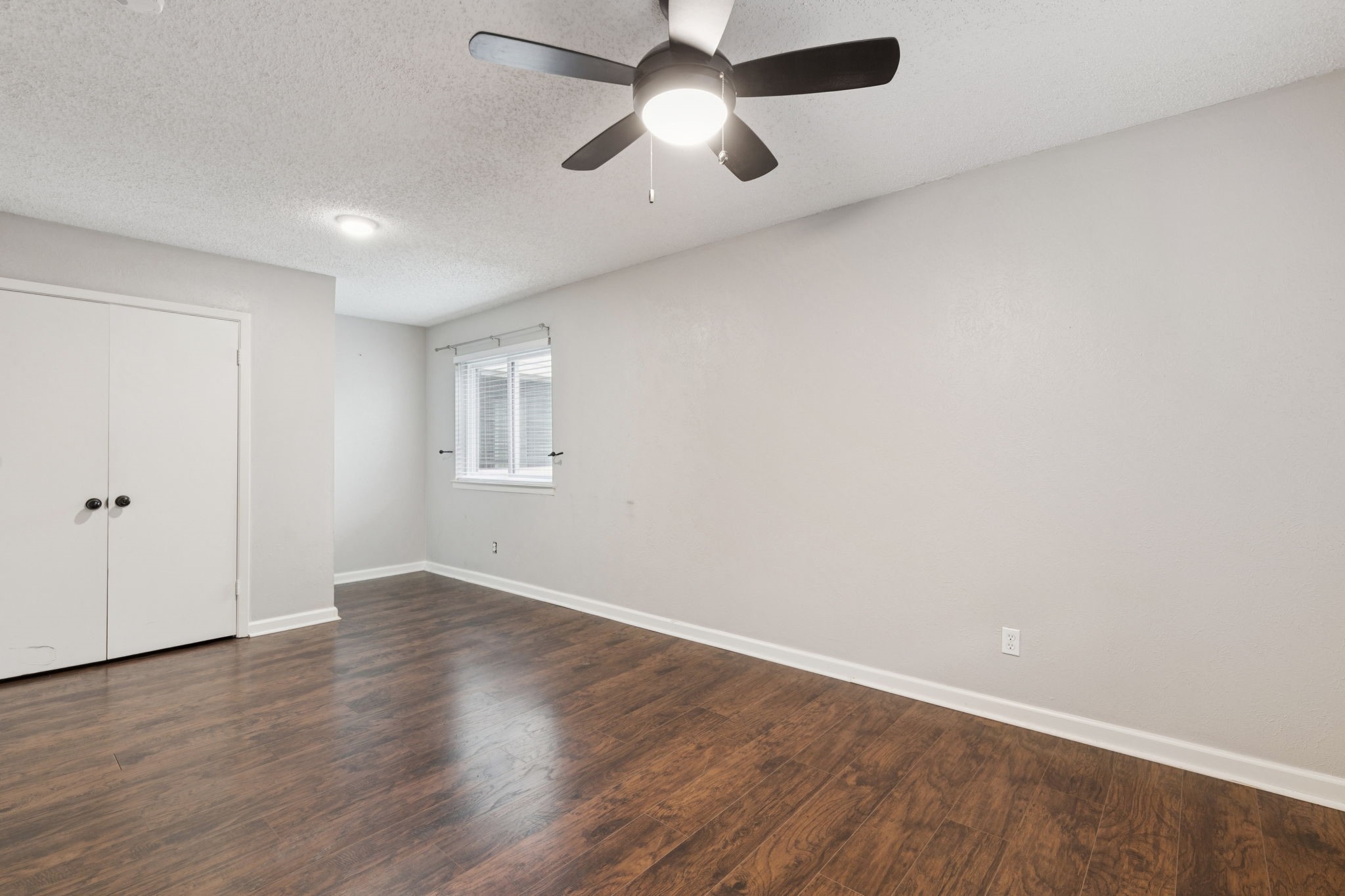 910 Via Valencia Mesquite, TX 75150 - Photo 21 of 23 an empty room with wooden floor ceiling fan and window
