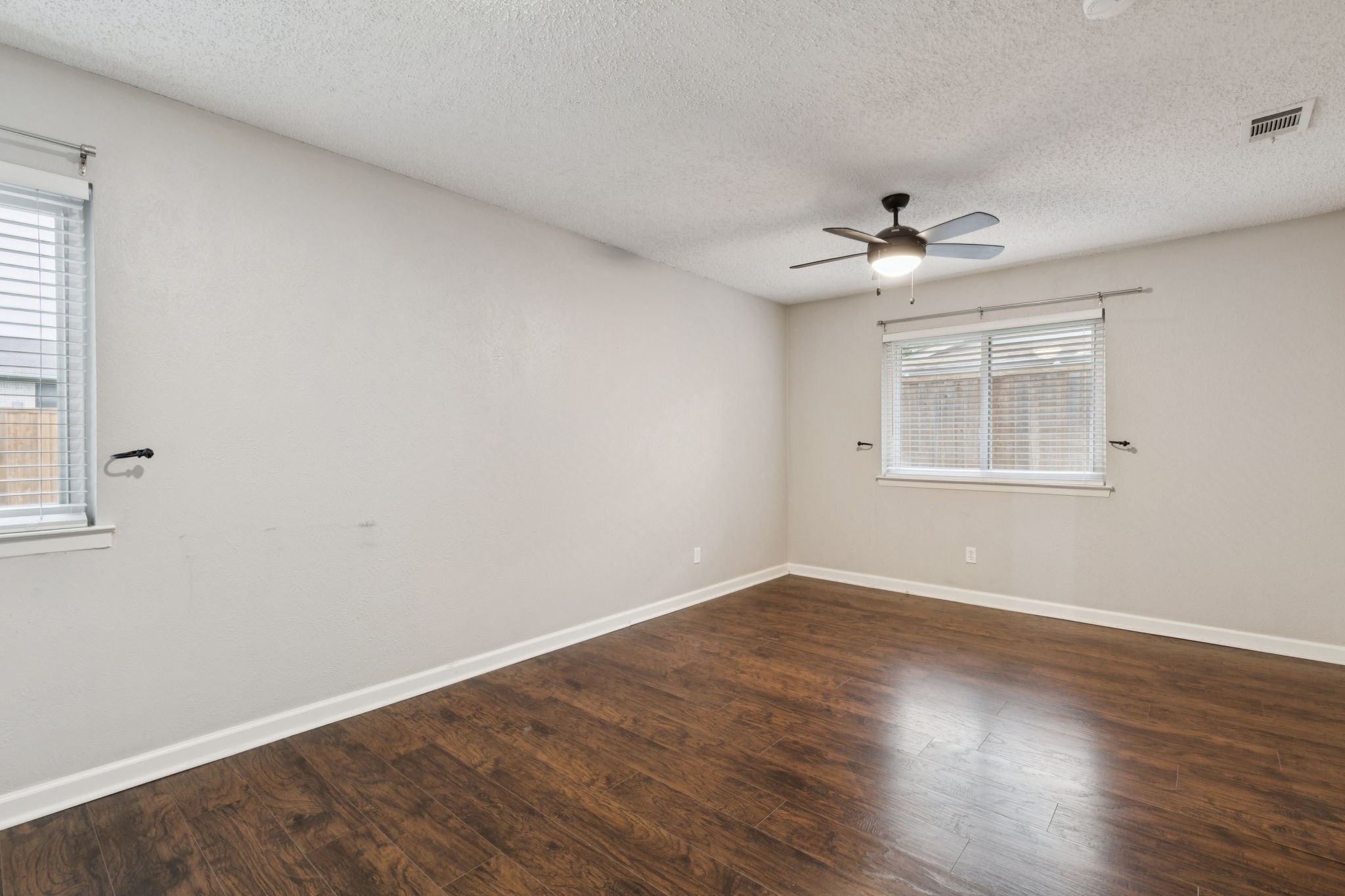 910 Via Valencia Mesquite, TX 75150 - Photo 22 of 23 a view of an empty room with a window and wooden floor