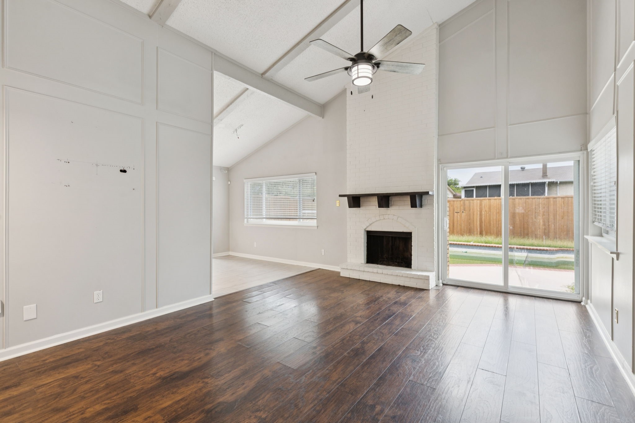 910 Via Valencia Mesquite, TX 75150 - Photo 4 of 23 an empty room with wooden floor fireplace and windows