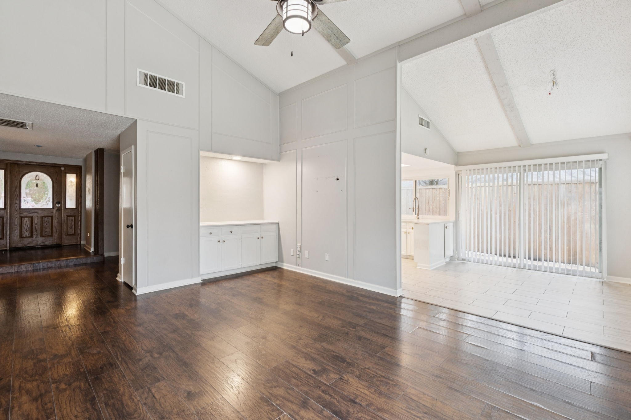 910 Via Valencia Mesquite, TX 75150 - Photo 5 of 23 an empty room with wooden floor cabinet and windows