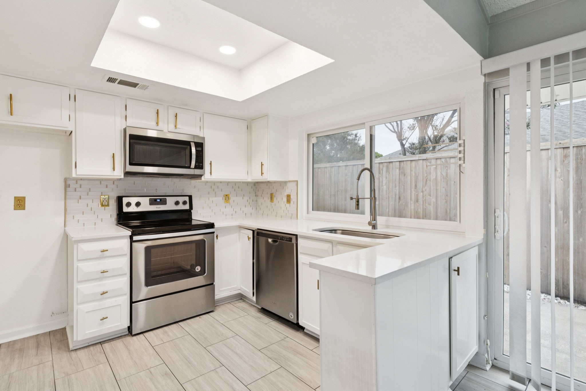 910 Via Valencia Mesquite, TX 75150 - Photo 10 of 23 a kitchen with a stove sink and microwave