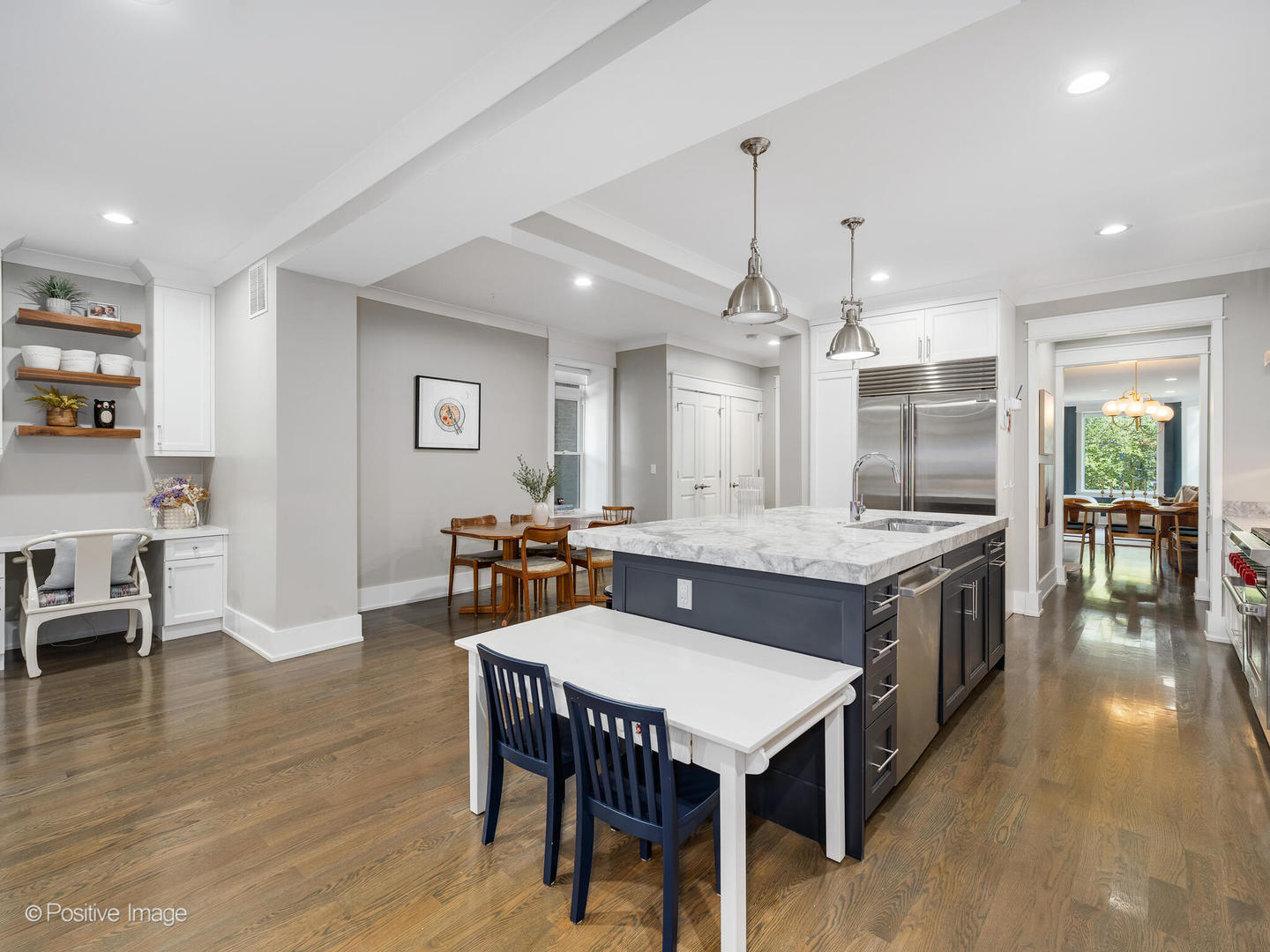 2315 West Roscoe Street, Unit 1 Chicago, IL 60618 - Photo 12 of 37 a kitchen with kitchen island a dining table chairs and wooden floor