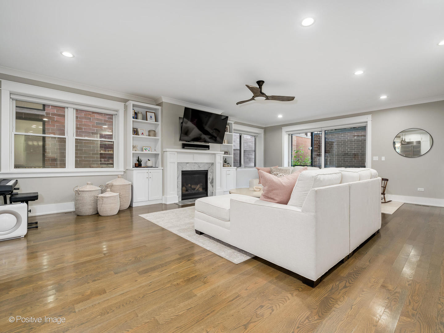 2315 West Roscoe Street, Unit 1 Chicago, IL 60618 - Photo 16 of 37 a living room with furniture a fireplace and a flat screen tv