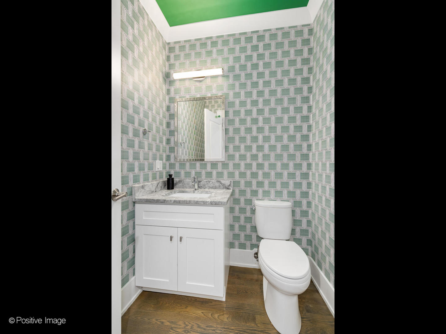 2315 West Roscoe Street, Unit 1 Chicago, IL 60618 - Photo 22 of 37 a bathroom with a toilet a sink and mirror