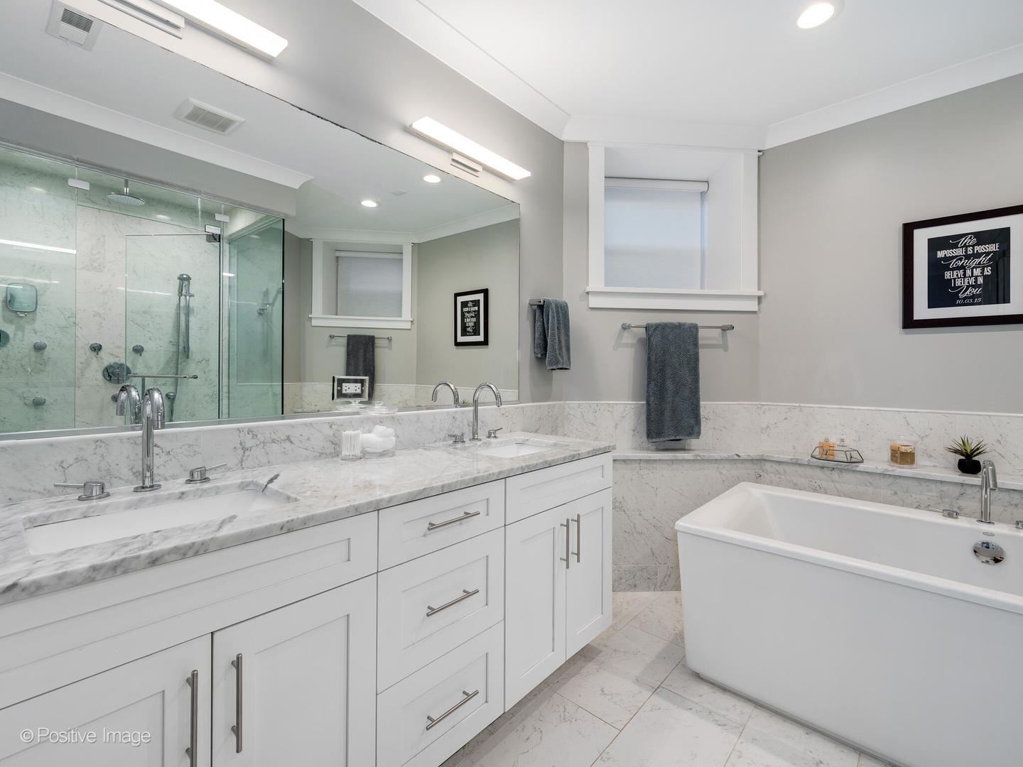 2315 West Roscoe Street, Unit 1 Chicago, IL 60618 - Photo 25 of 37 a bathroom with a granite countertop sink a large mirror and a bathtub