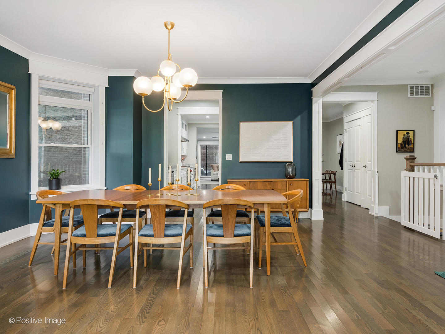 2315 West Roscoe Street, Unit 1 Chicago, IL 60618 - Photo 6 of 37 a dining room with wooden floor a chandelier a wooden table and chairs