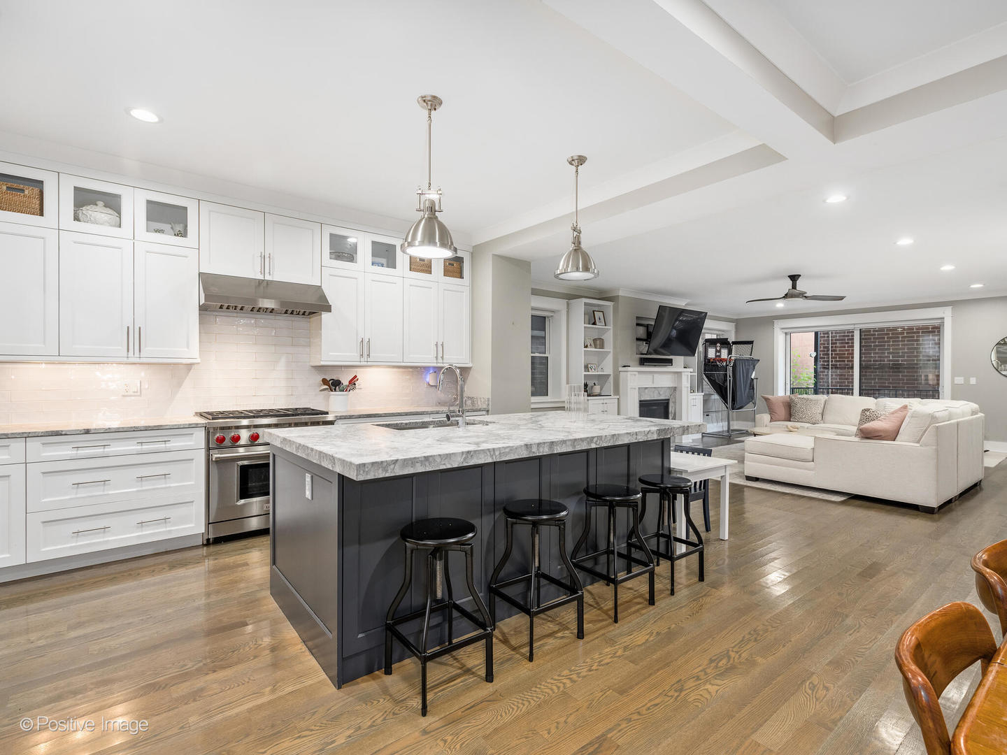 2315 West Roscoe Street, Unit 1 Chicago, IL 60618 - Photo 10 of 37 a kitchen with stainless steel appliances granite countertop a stove and chairs wooden floor