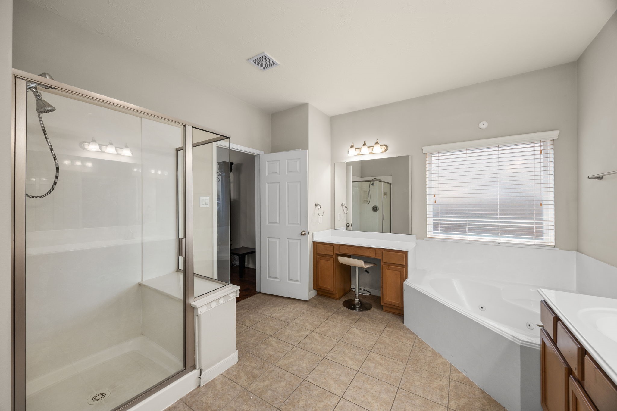 6719 Latchmore Lane Houston, TX 77049 - Photo 28 of 46 a spacious bathroom with a bathtub shower and sink