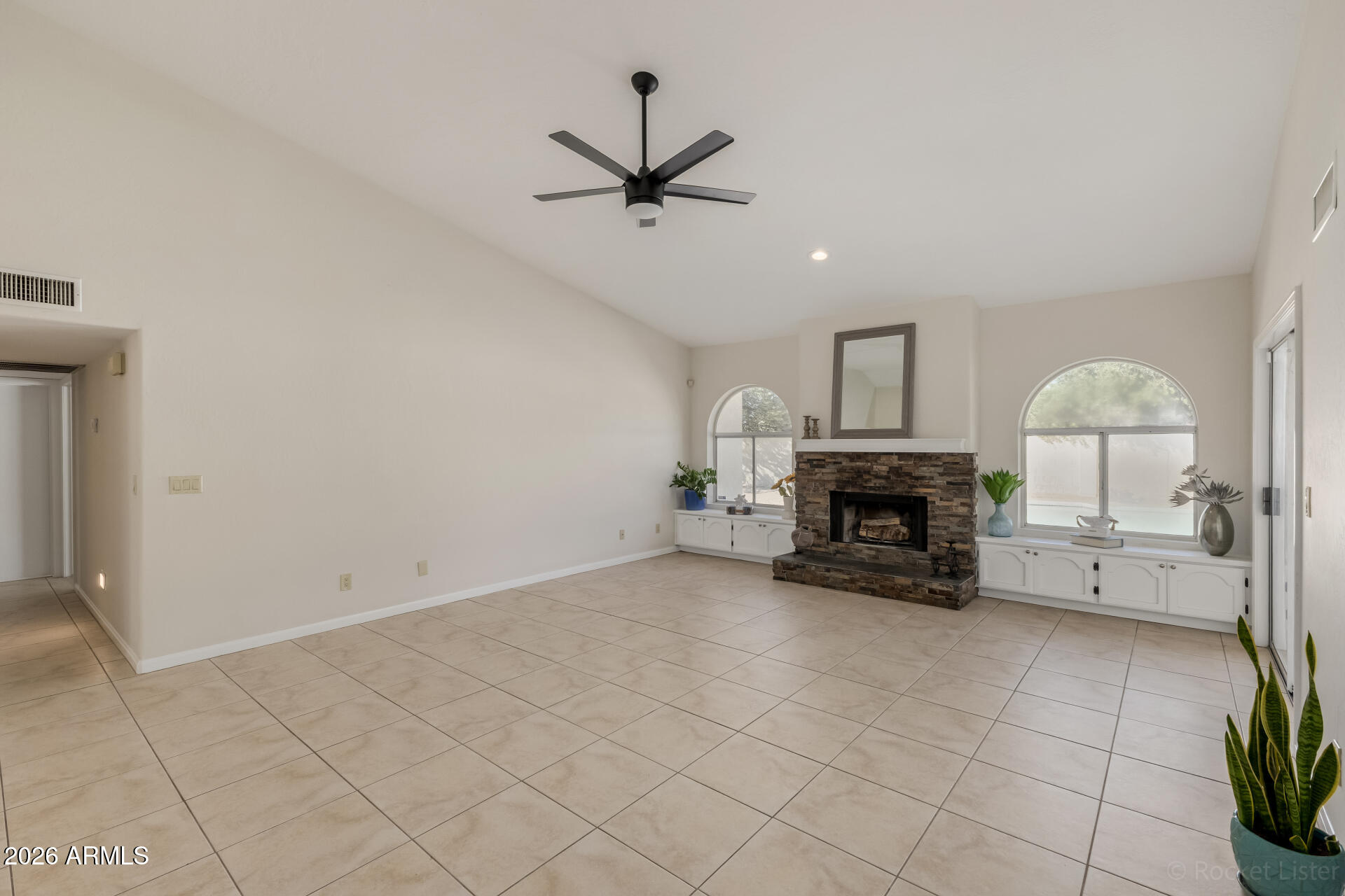 5116 East Wethersfield Road Scottsdale, AZ 85254 - Photo 11 of 53 an empty room with fireplace and windows