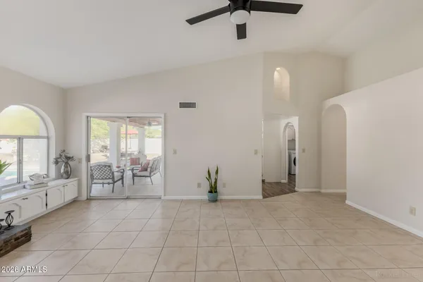 a view of empty room with cabinet and fan