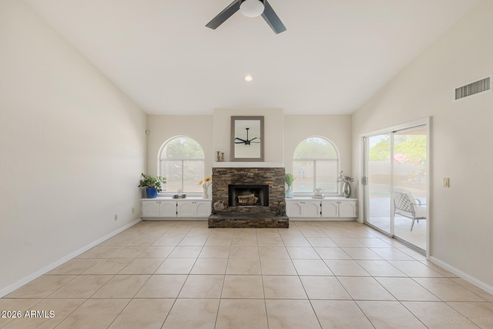 5116 East Wethersfield Road Scottsdale, AZ 85254 - Photo 13 of 53 a living room with furniture and a fireplace