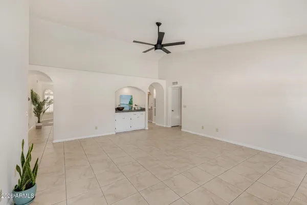 a view of a room with wooden floor and a potted plant