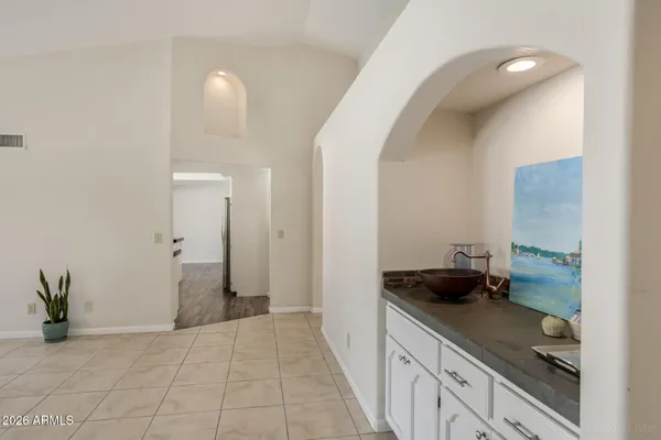 a kitchen with a refrigerator and a stove top oven