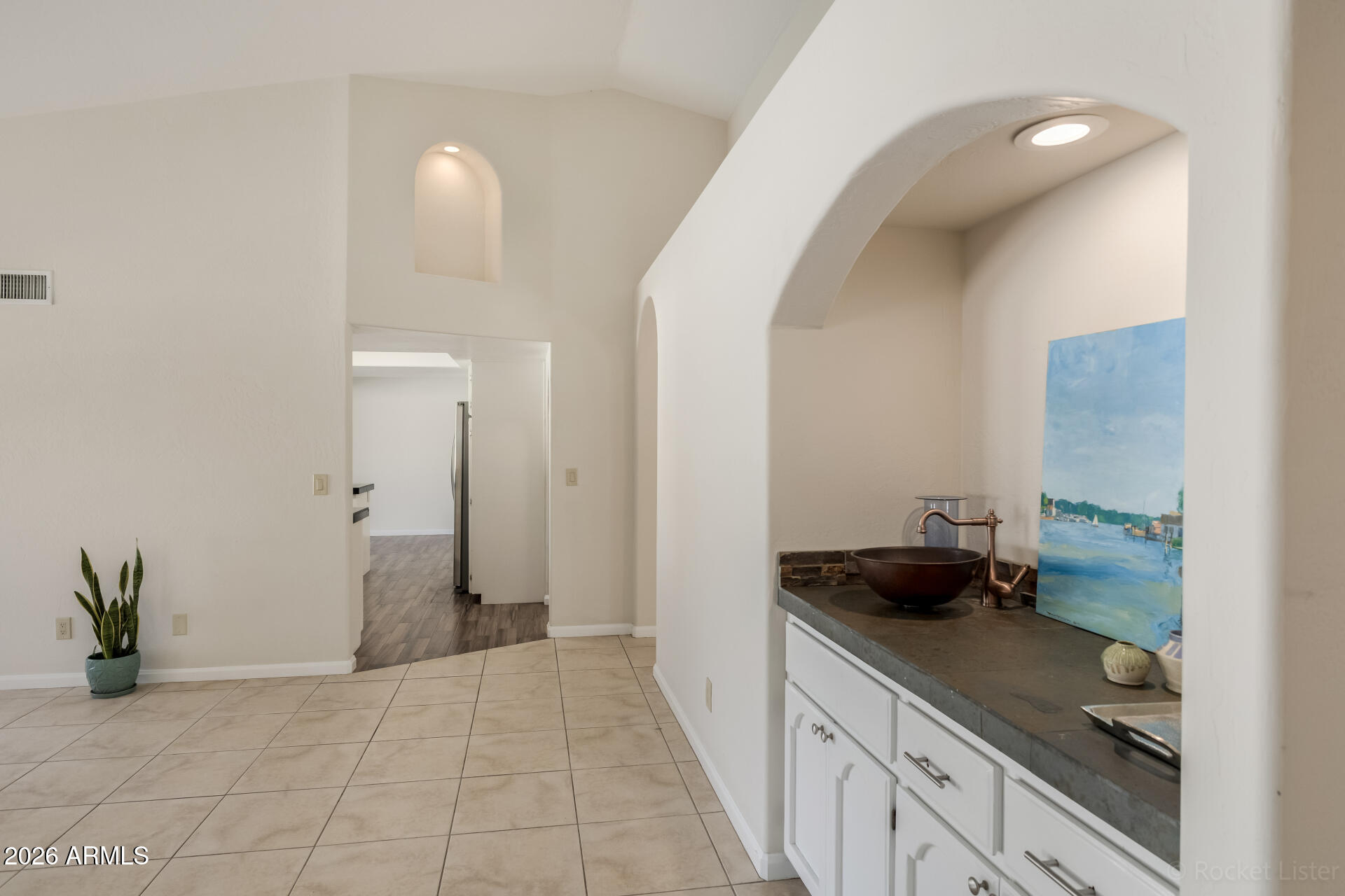 5116 East Wethersfield Road Scottsdale, AZ 85254 - Photo 16 of 53 a kitchen with a sink and cabinets